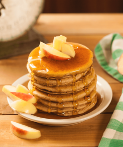 Stack of pancakes with apple slices