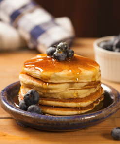 Stack of blueberry pancakes with blueberry toppings