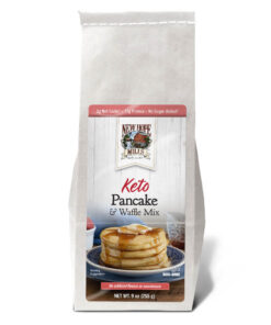 Keto Pancake mix packaging front, showing prepared pancakes and text "2g Net Carbs, 17 g Protein, No Sugar Added" and "Keto Pancake & Waffle Mix with No artificial flavors or sweeteners; OU D (Kosher dairy), Non-GMO; Net Weight 9 oz (255g)"