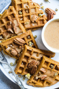 Photo of prepared waffles with a glaze and walnuts