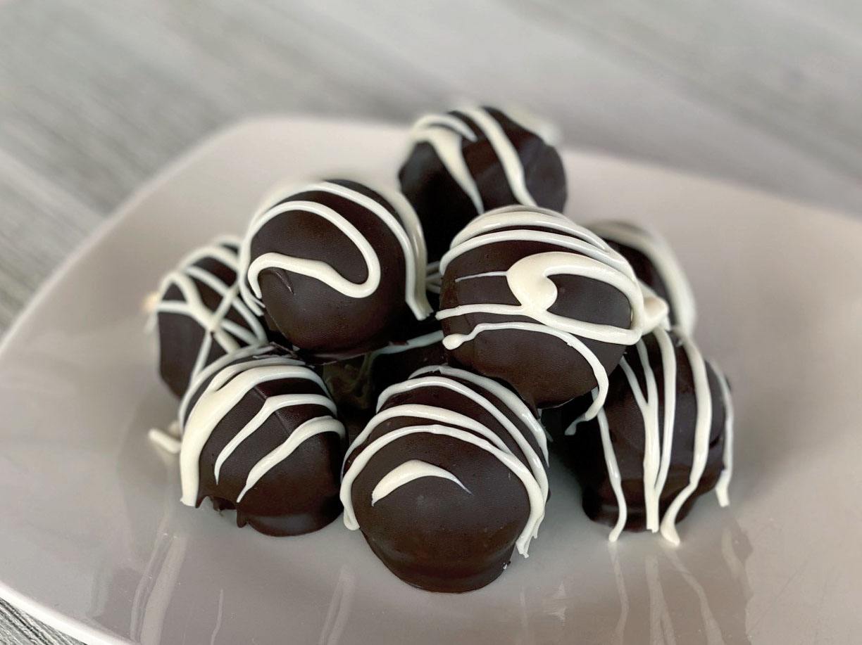 Hot cocoa truffles on a white plate