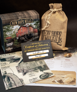 Photo of New Hope Mills Jigsaw Puzzle: Collector's Edition, with contents displayed (including canvas pouch for pieces, Certificate of Authenticity, and printouts with historical information in imagery.
