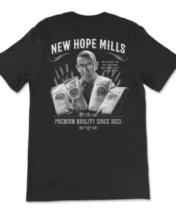 T-Shirt Back; black with white "New Hope Mills" and "Premium Quality Since 1823" text with an image of Leland Weed holding bags pancake mix