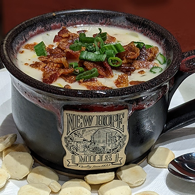 A photo of the January special "Sheffield Chowder", featuring a blend of clam, shrimp, and bay scallops in a creamy soup, brimming with potato, carrot, celery, and bacon