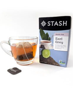 Stash Earl grey tea box with a cup of brewed tea