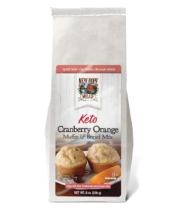 Front of the Keto Cranberry Orange Muffin & Bread Mix, showing delicious looking muffins with cranberries and an orange piece on a plate.