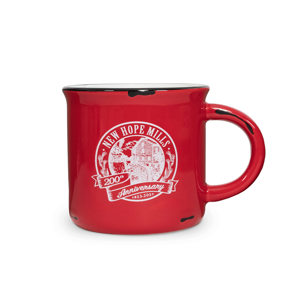 Photo of a simple red mug printed with the 200th Anniversary New Hope Mills logo in white
